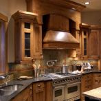 Rustic Kitchen Design With Pro Viking Range, Large Wood Hood, And